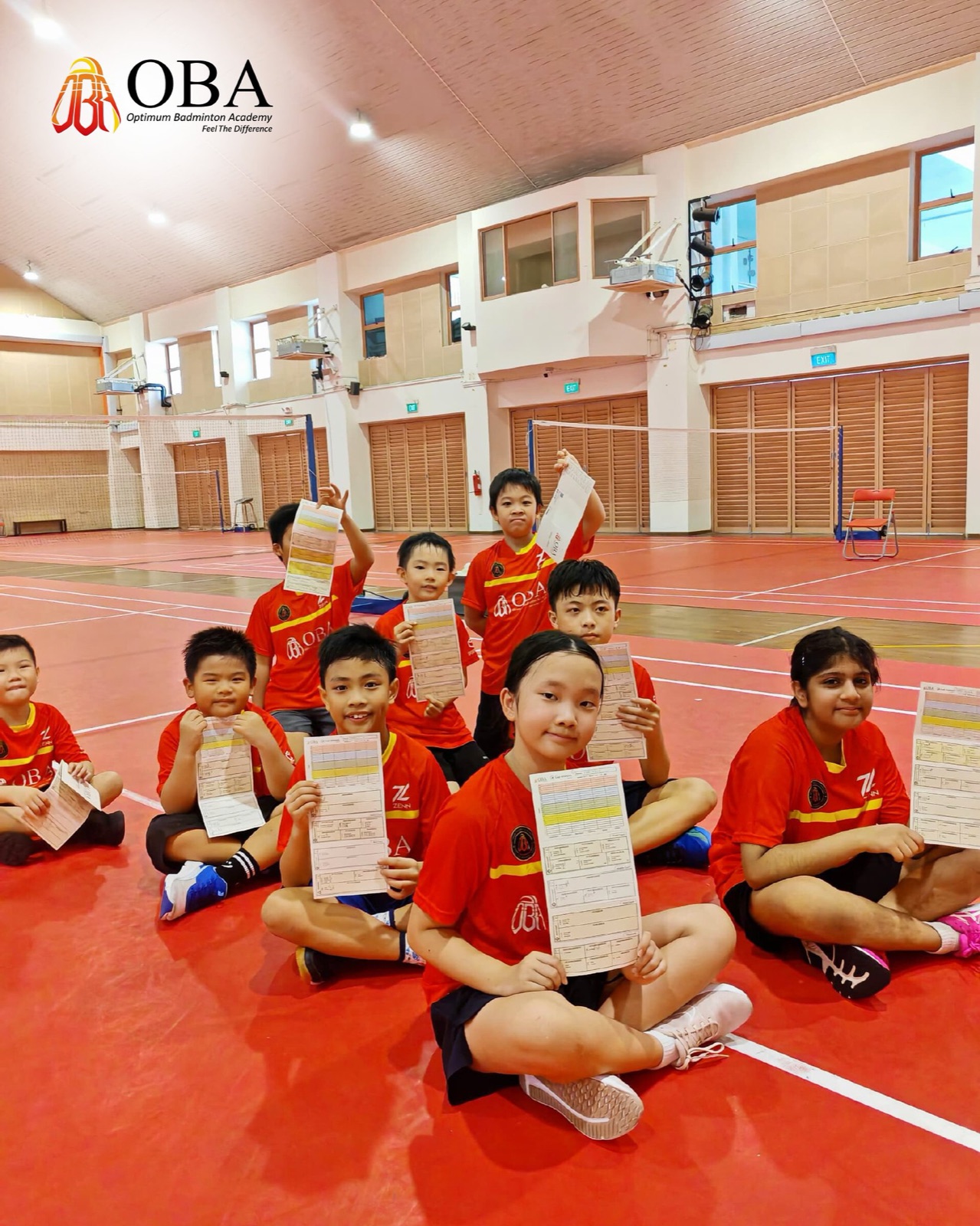Group of campers sitting together holding up their camp cards