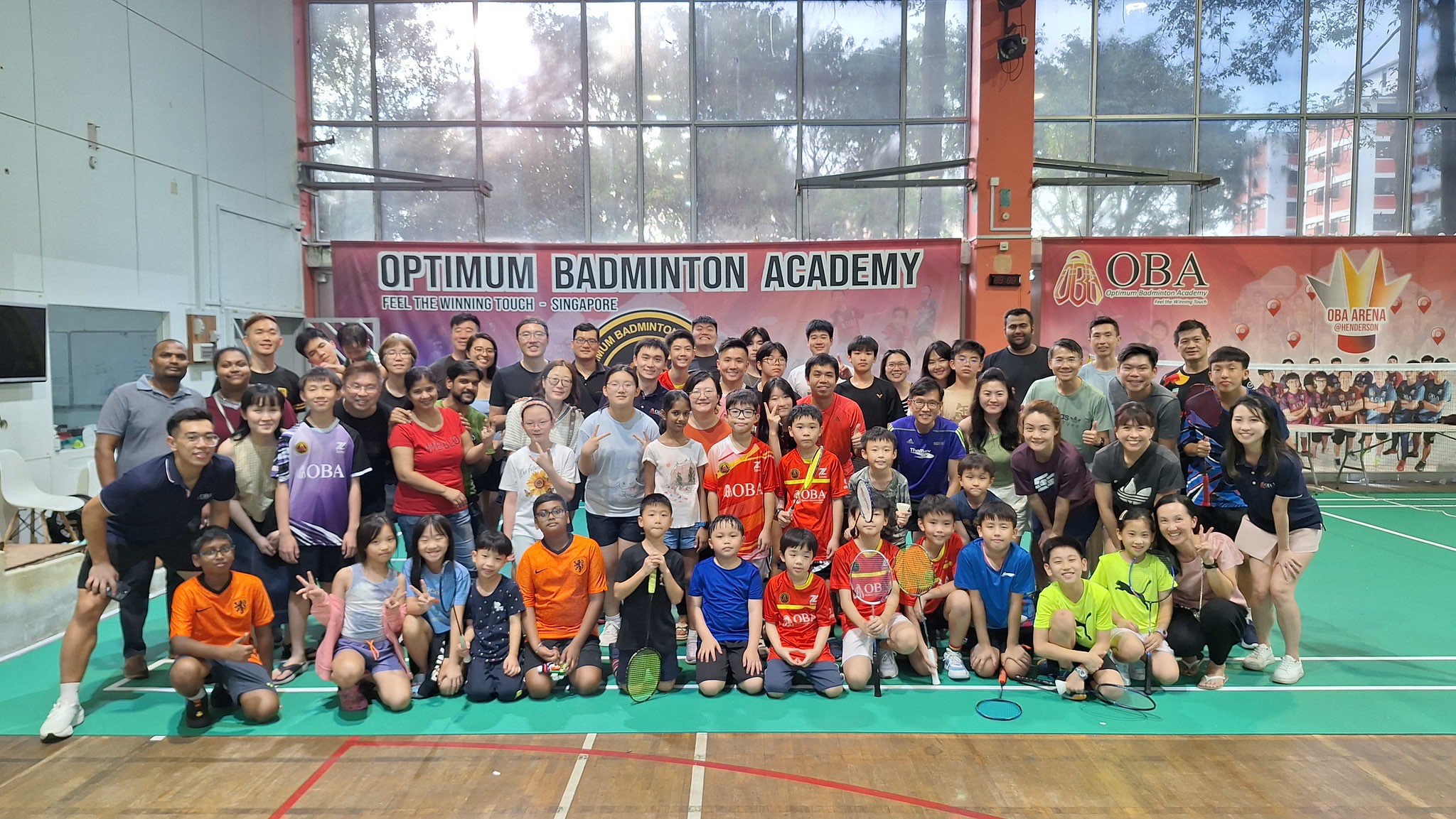 The whole academy gathered on court under the Optimum Badminton Academy banner