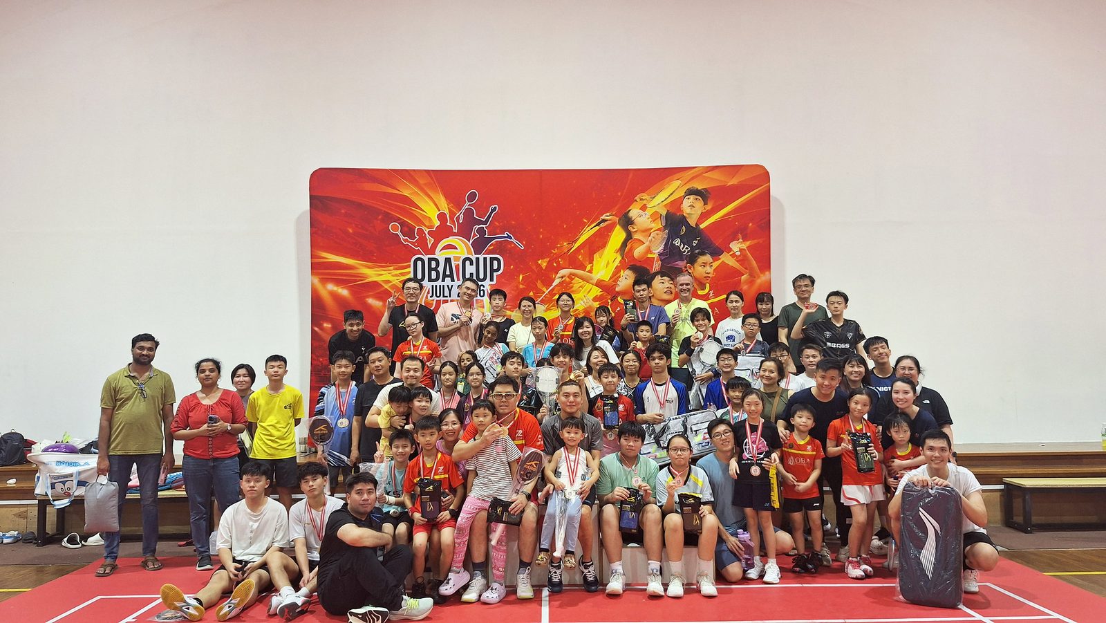 The whole group of players gathered in front of the OBA Cup backdrop